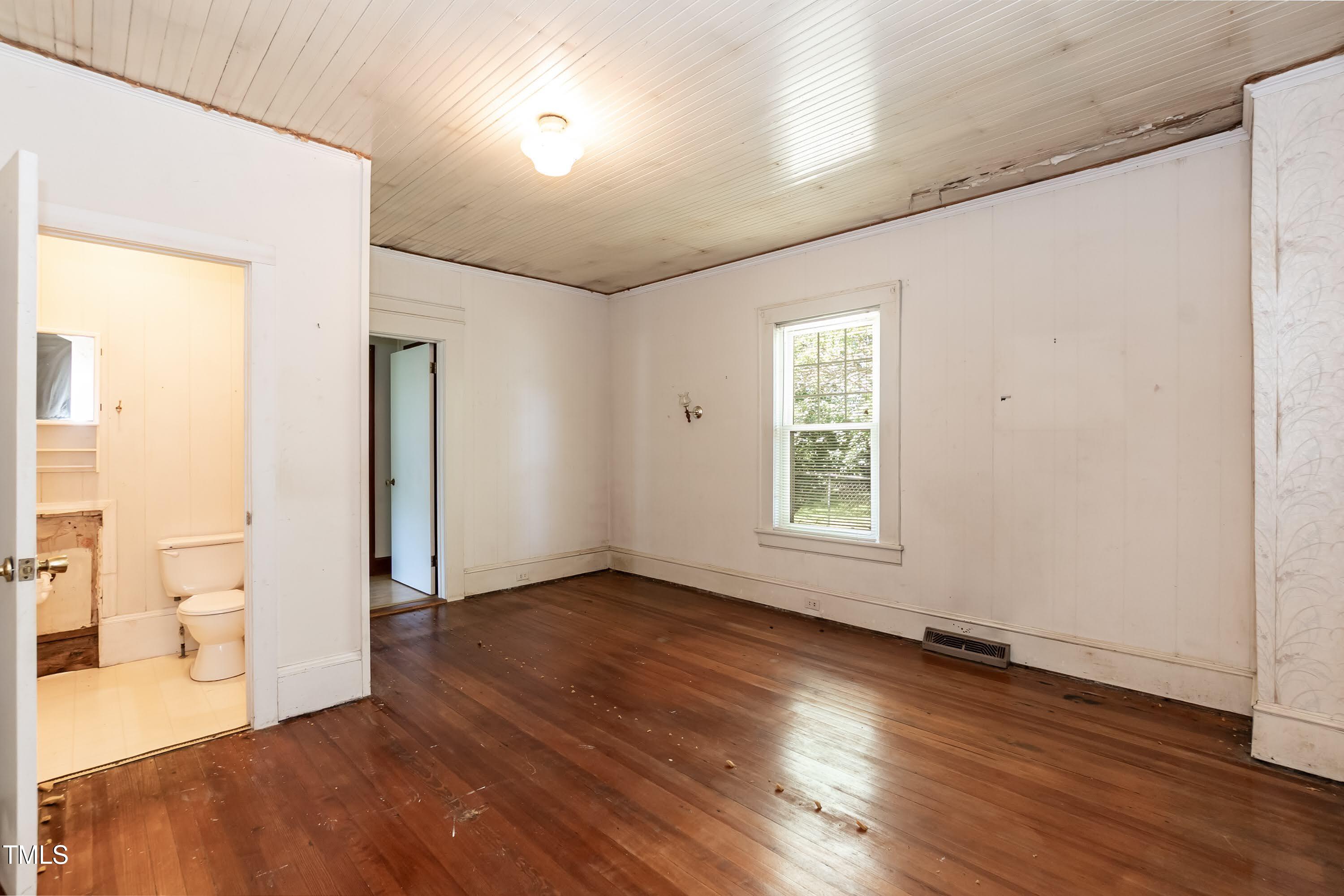 310 Spring Street Durham, NC 27703 - Photo 32 of 43 a view of an empty room with wooden floor and a window