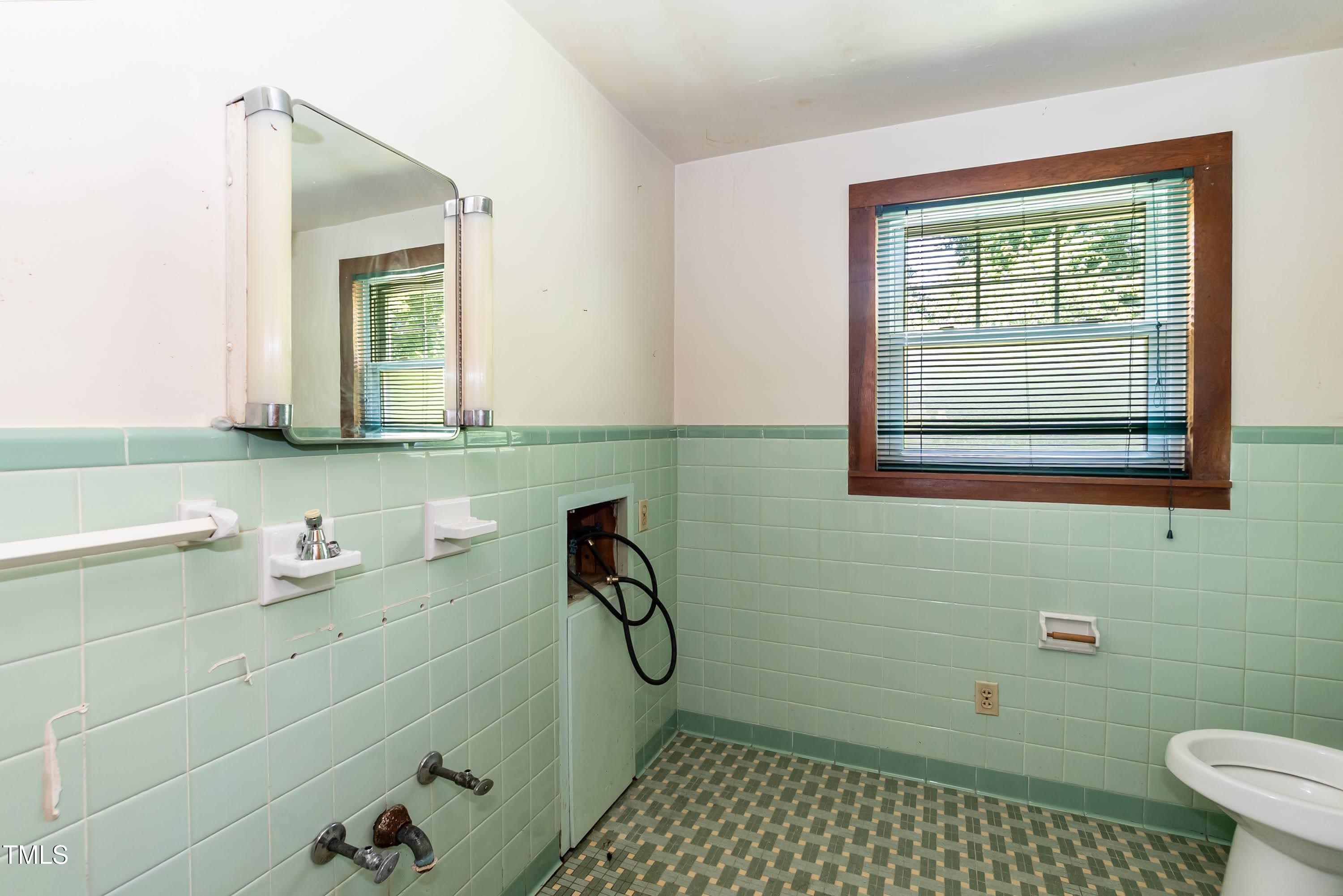 310 Spring Street Durham, NC 27703 - Photo 36 of 43 a bathroom with a sink toilet and window