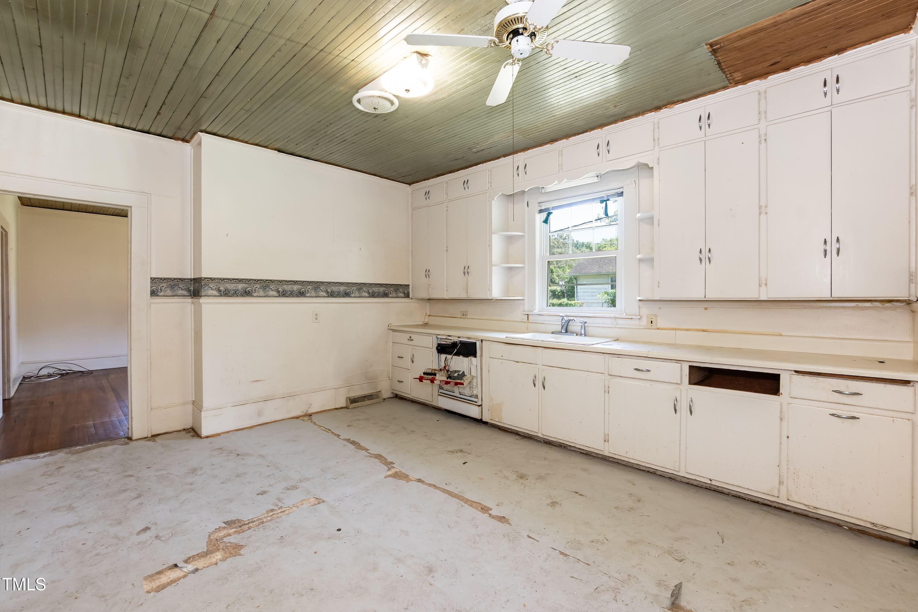 310 Spring Street Durham, NC 27703 - Photo 38 of 43 a kitchen with a refrigerator a white cabinets and sink
