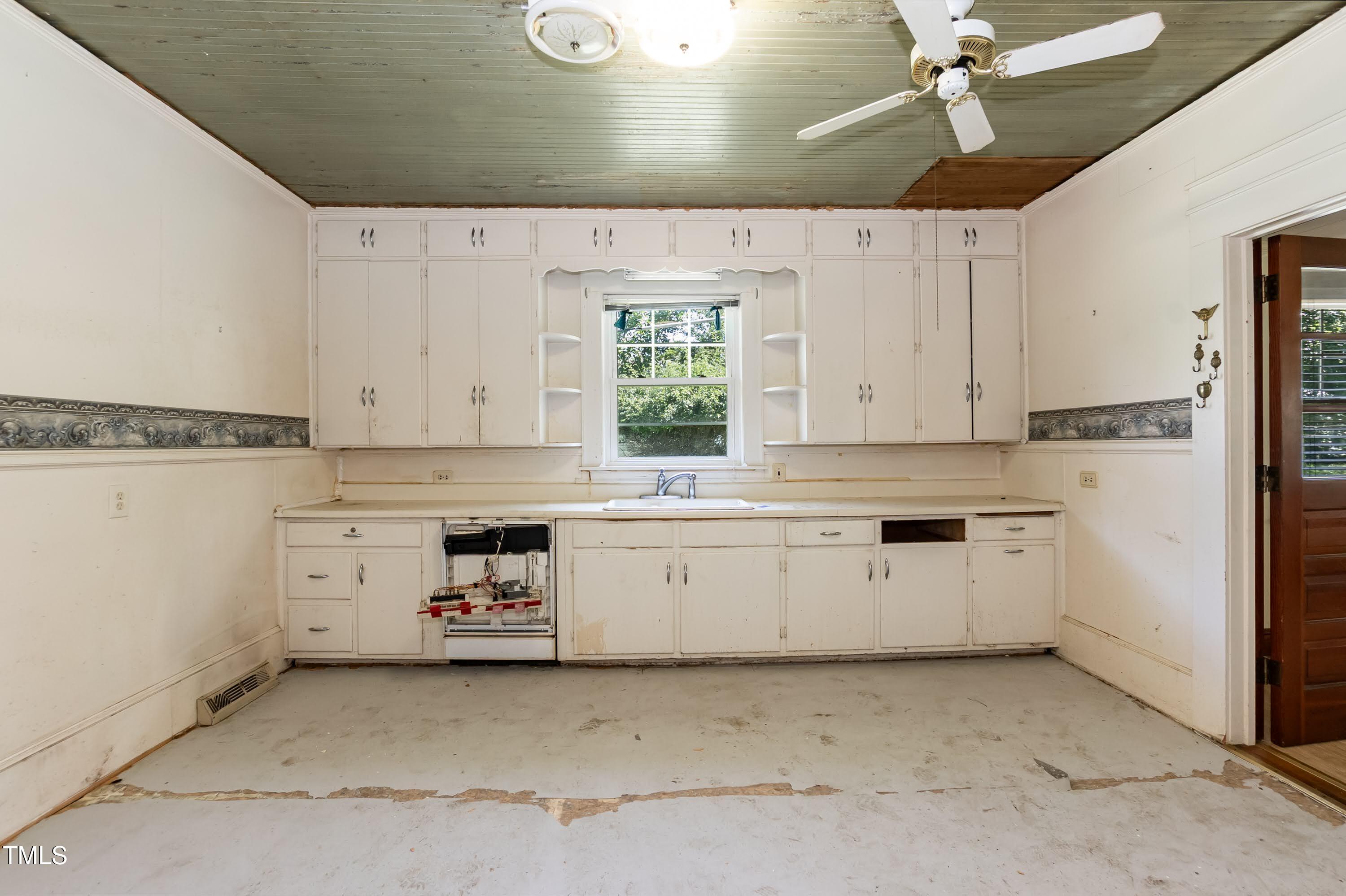 310 Spring Street Durham, NC 27703 - Photo 39 of 43 a kitchen with white cabinets and white appliances
