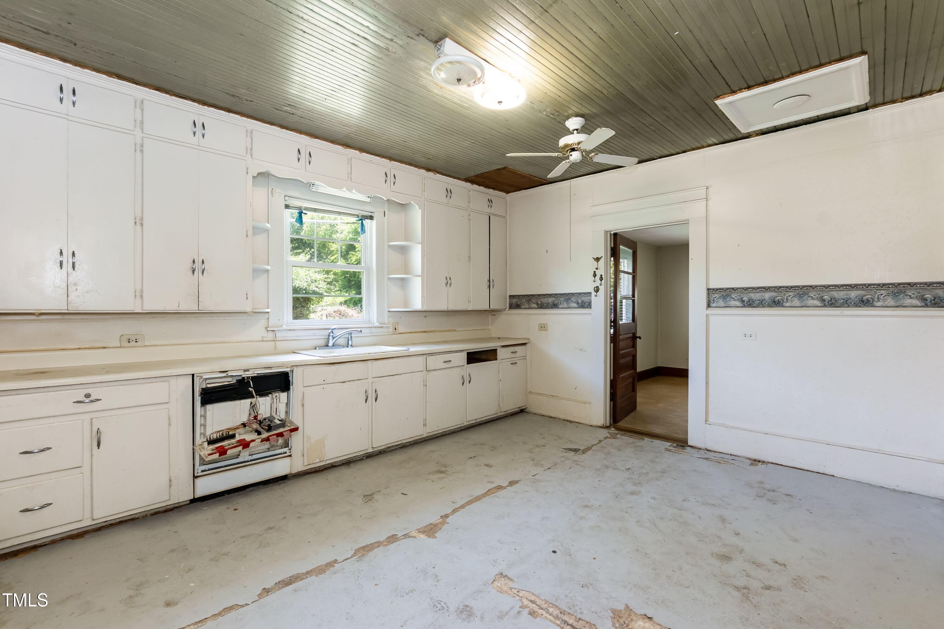 310 Spring Street Durham, NC 27703 - Photo 40 of 43 a kitchen with a white stove refrigerator and white cabinets