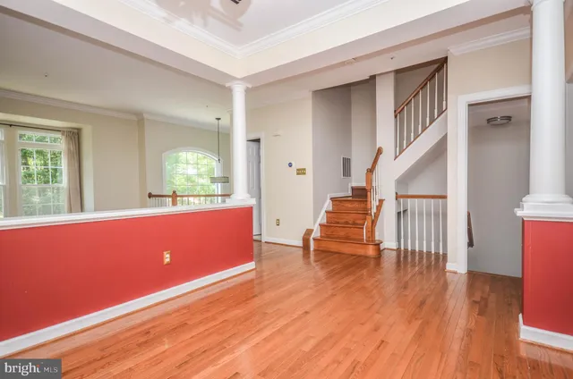 a room with stairs and wooden floor