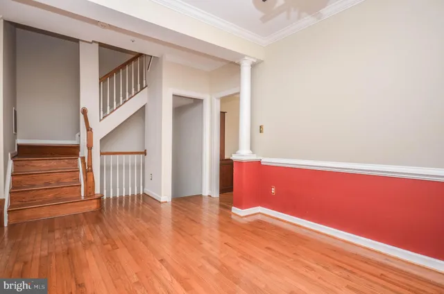 a view of empty room with wooden floor