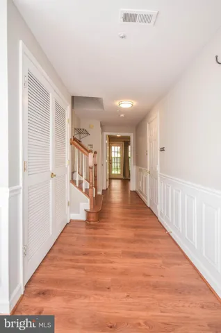 a view of a hallway with wooden floor
