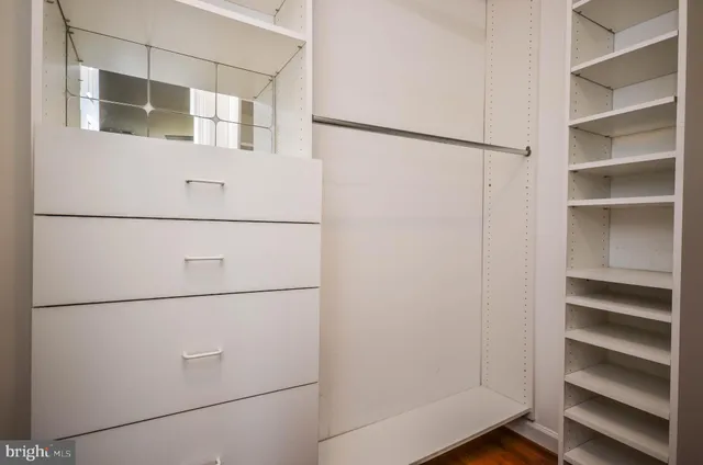 a view of a room with wooden floor and window