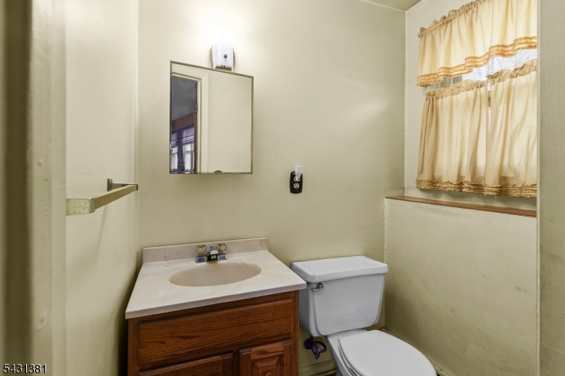 1089 Green Pond Road Newfoundland, NJ 07435 - Photo 23 of 34 a white toilet sitting next to a bathroom sink