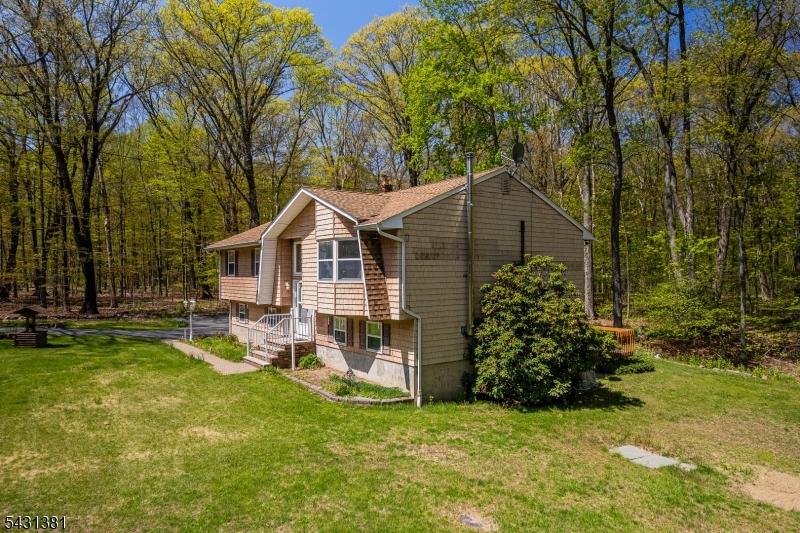 1089 Green Pond Road Newfoundland, NJ 07435 - Photo 27 of 34 a view of a house with a yard porch and sitting area