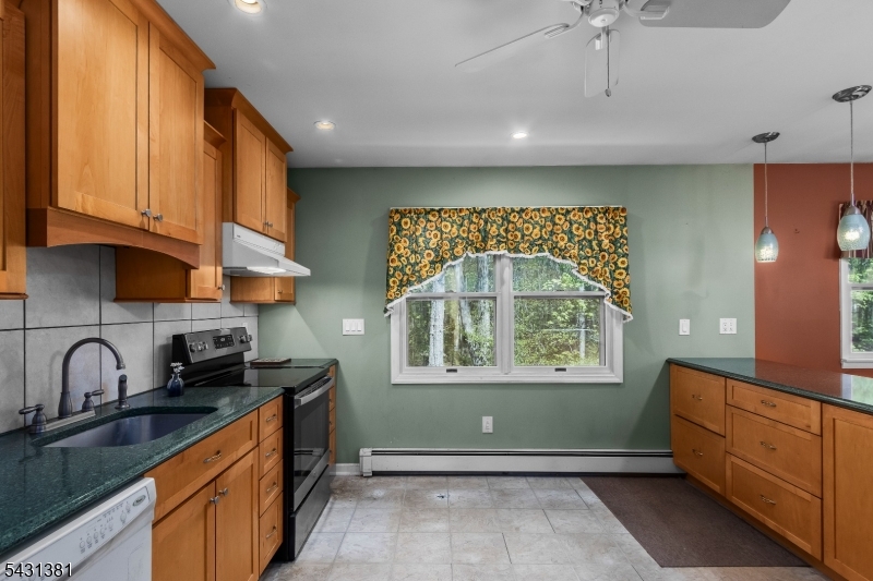 1089 Green Pond Road Newfoundland, NJ 07435 - Photo 5 of 34 a kitchen with granite countertop a stove and a sink