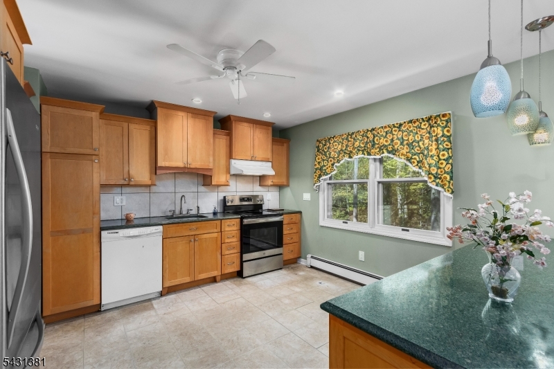 1089 Green Pond Road Newfoundland, NJ 07435 - Photo 7 of 34 a kitchen with stainless steel appliances granite countertop a stove refrigerator and cabinets