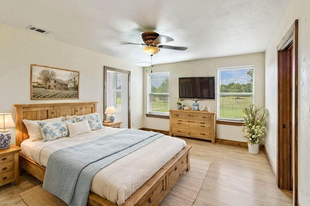 800 County Road 2807 Mabank, TX 75147 - Photo 19 of 39 a bedroom with a bed and a flat tv screen on dresser
