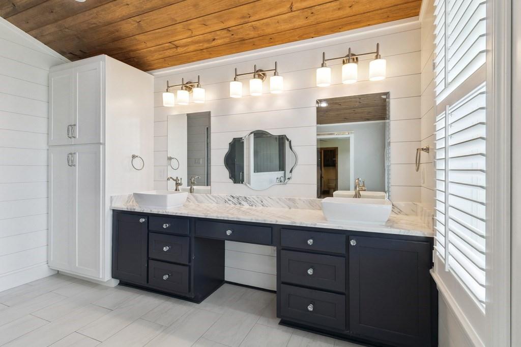 800 County Road 2807 Mabank, TX 75147 - Photo 22 of 39 a bathroom with a granite countertop double vanity sink and a mirror