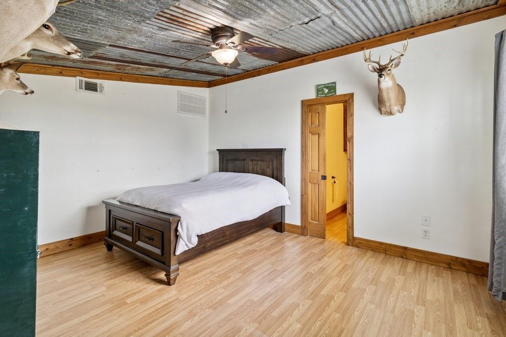 800 County Road 2807 Mabank, TX 75147 - Photo 26 of 39 a bedroom with a bed and wooden floor