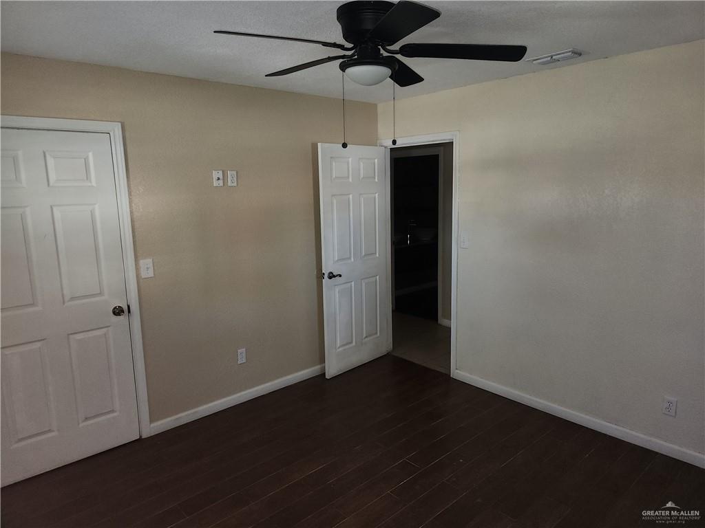 3021 Nyssa Avenue McAllen, TX 78501 - Photo 15 of 24 an empty room with wooden floor a ceiling fan and stainless steel appliances