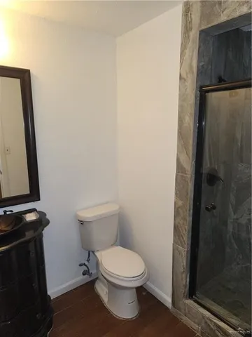 a white toilet sitting next to a bathroom sink