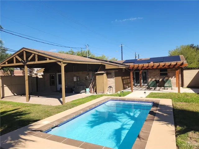 a view of a house with swimming pool and porch