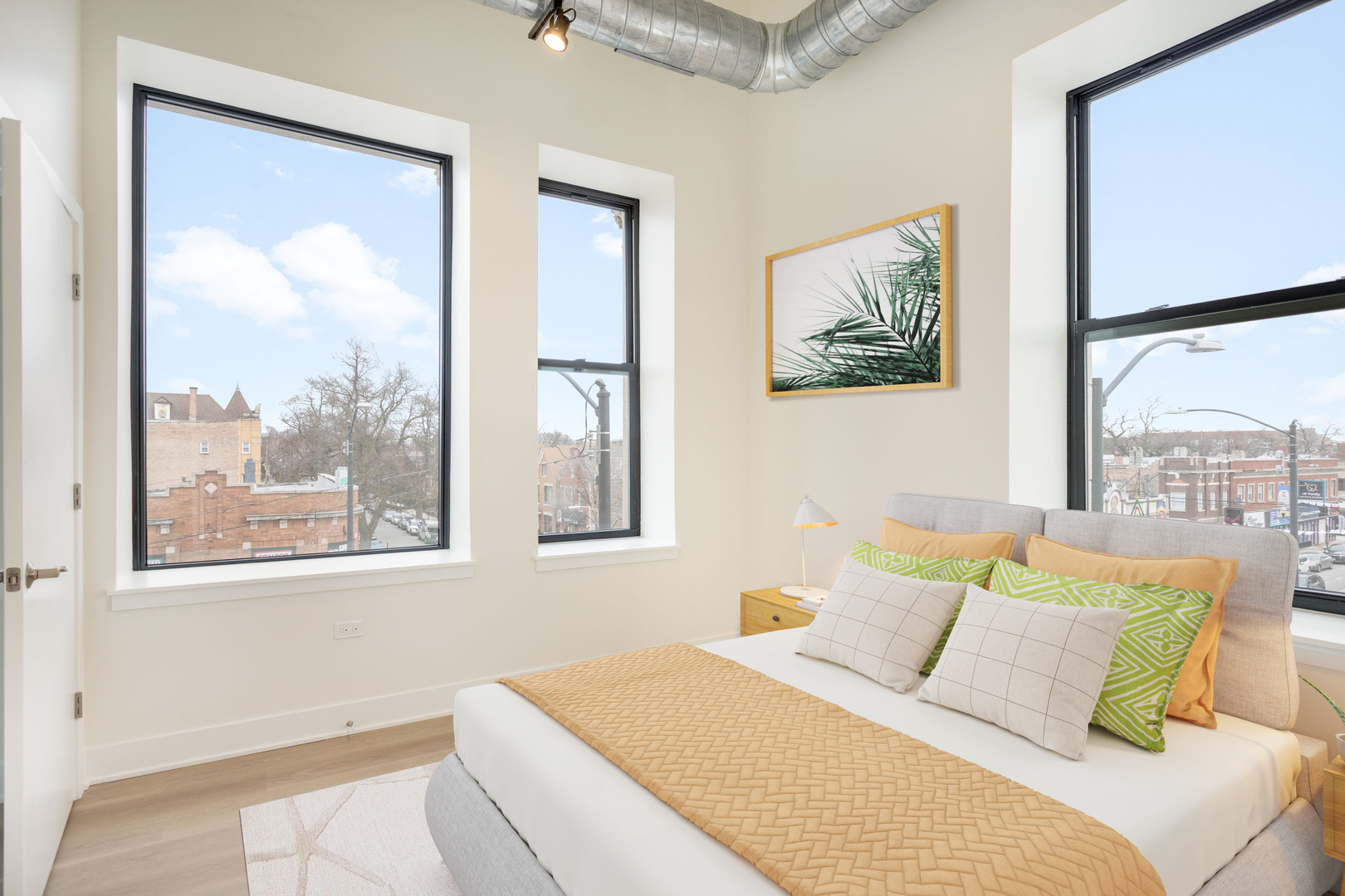 3801 West 26th Street, Unit 301 Chicago, IL 60623 - Photo 5 of 12 a bedroom with a large bed and a painting on the wall