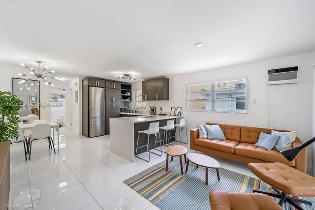 a living room with furniture and kitchen view