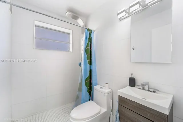 a bathroom with a sink toilet and vanity