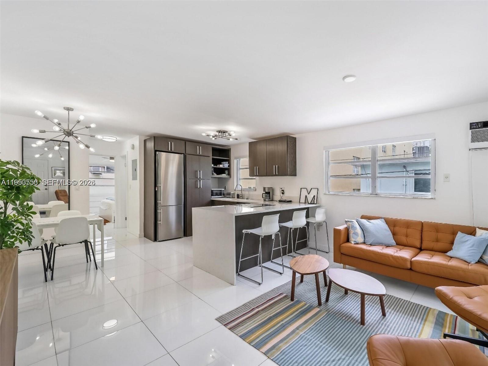 710 11th Street, Unit 8 Miami Beach, FL 33139 - Photo 5 of 15 a living room with furniture and kitchen view