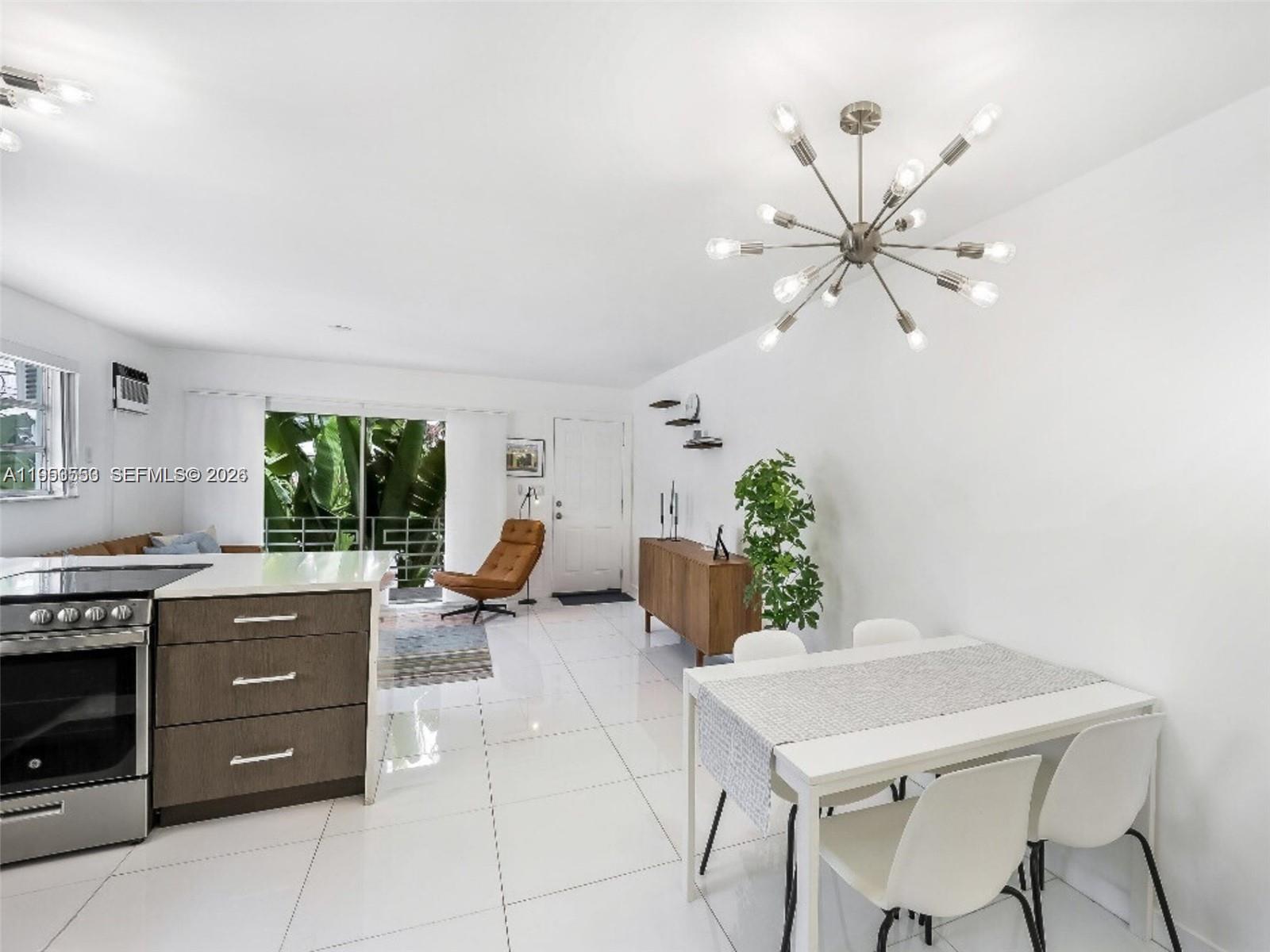 710 11th Street, Unit 8 Miami Beach, FL 33139 - Photo 10 of 15 a living room with furniture and a large window