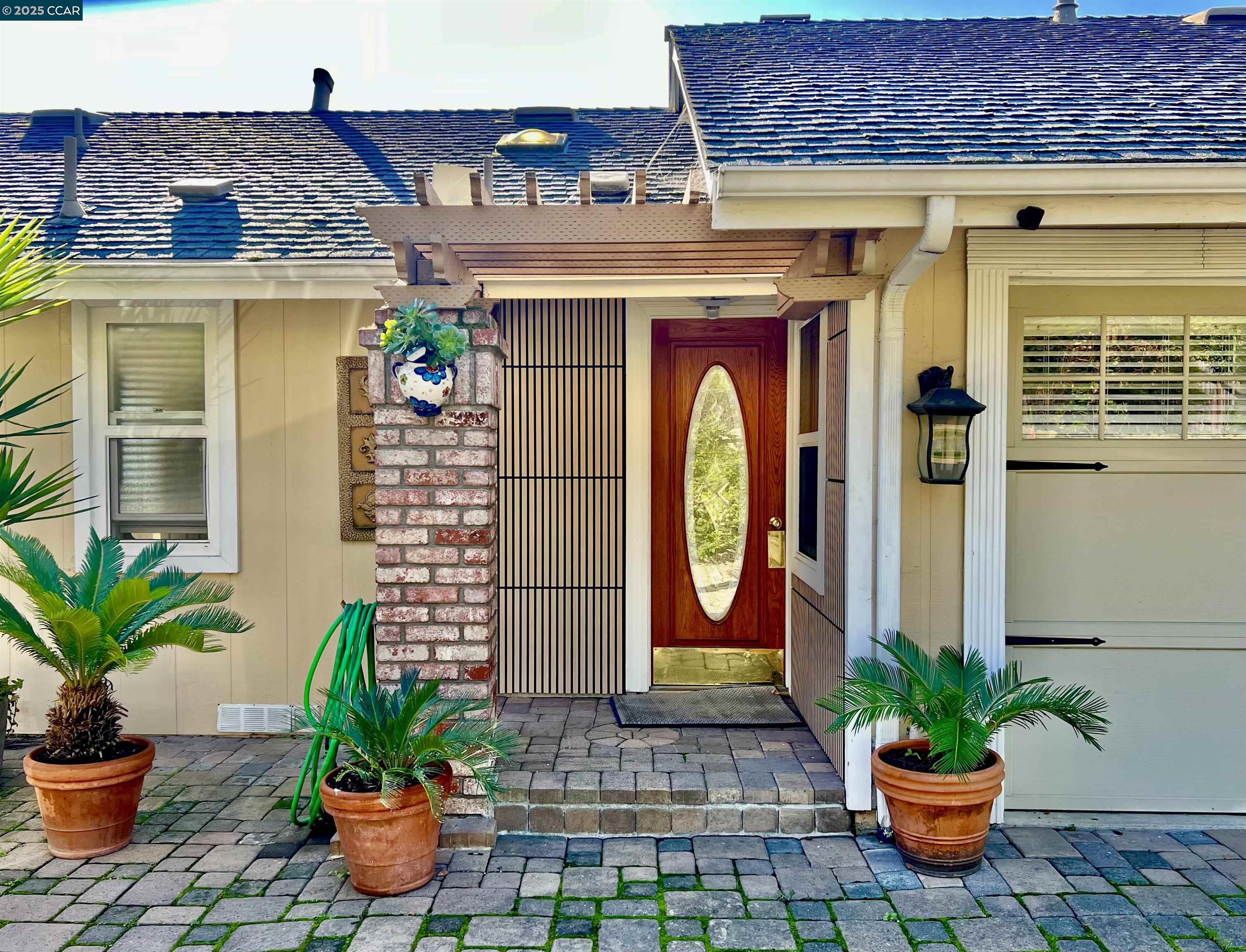 a front view of a house with a potted plants