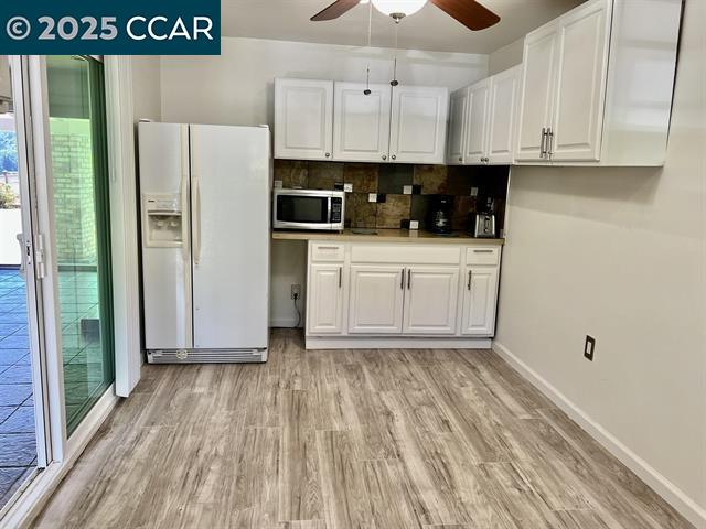 35.5 Kent Court Moraga, CA 94556 - Photo 12 of 17 a kitchen with cabinets appliances and a wooden floor