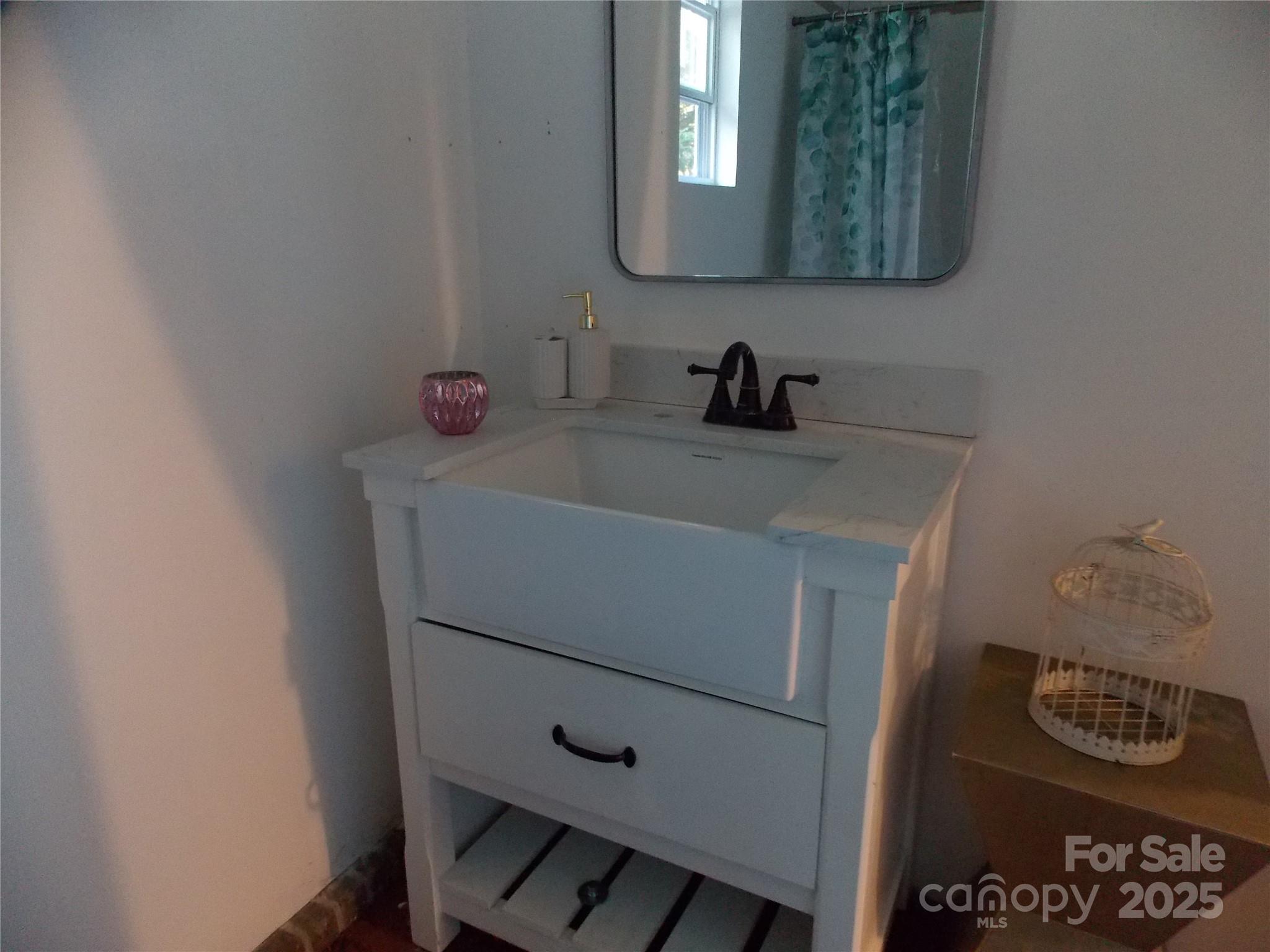 314 Cypress Street Hudson, NC 28638 - Photo 13 of 16 a bathroom with a sink and a mirror