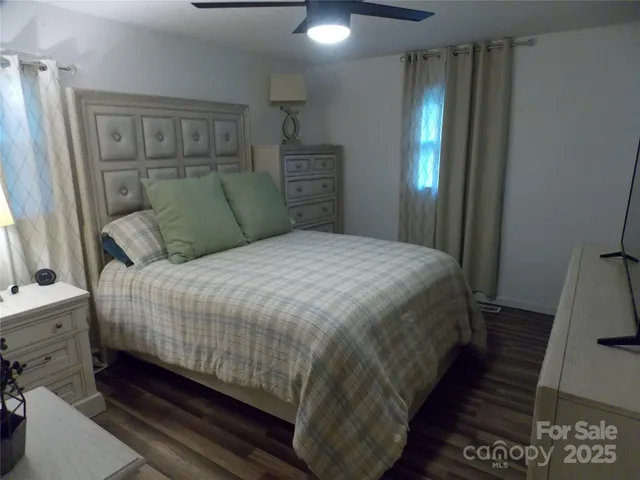 a bedroom with a bed and a mirror