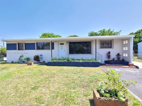 a front view of house with yard and seating area