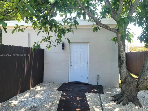 a backyard of a house with table and chairs