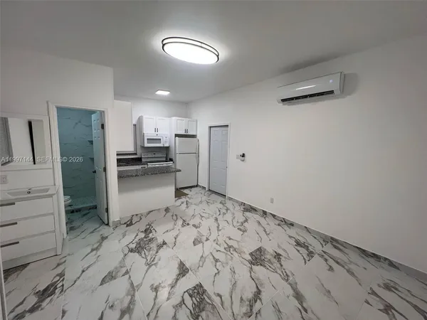 a kitchen with a refrigerator and a stove