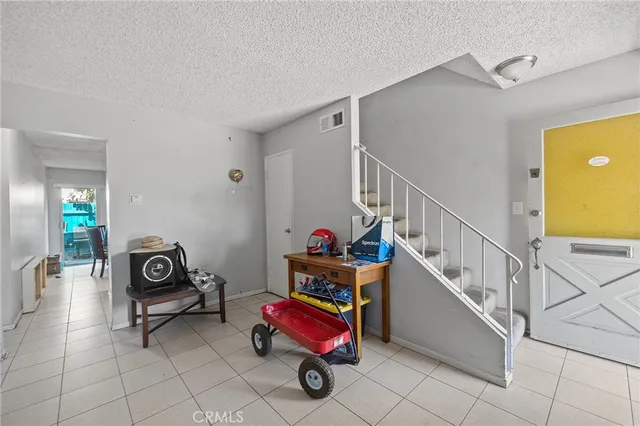 a kitchen with refrigerator a sink a stove and white cabinets