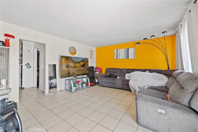 a kitchen with a refrigerator a microwave a sink and cabinets