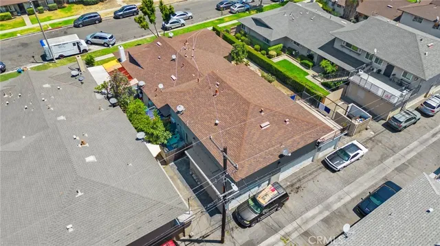 an aerial view of residential houses with outdoor space and street view