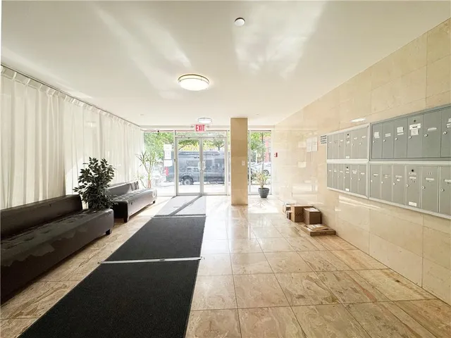 a lobby with furniture and floor to ceiling window