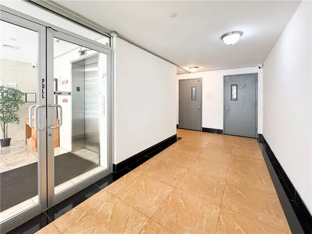a view of hallway with bathroom