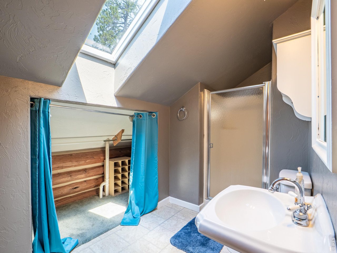 296 Caddo Road Red Feather Lakes, CO 80545 - Photo 22 of 50 3/4 bath off of loft space with closet area & skylight.