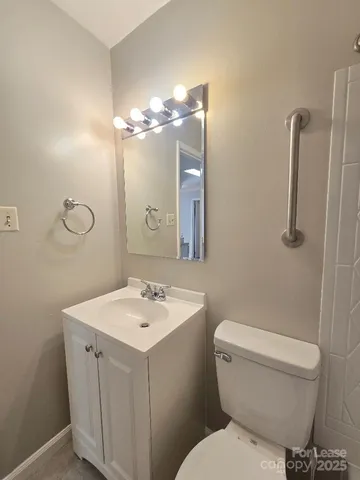a bathroom with a toilet a sink and a mirror