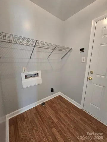 a view of a room with wooden floor