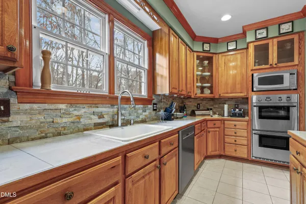 a kitchen with stainless steel appliances kitchen island granite countertop a sink and cabinets