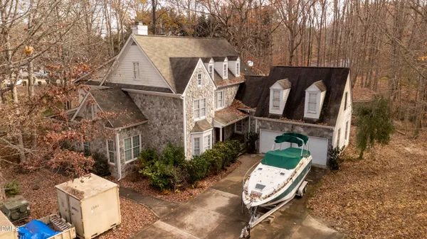 a aerial view of a house with a yard and sitting area