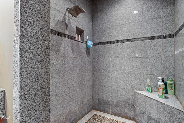 a bathroom with a toilet and a shower