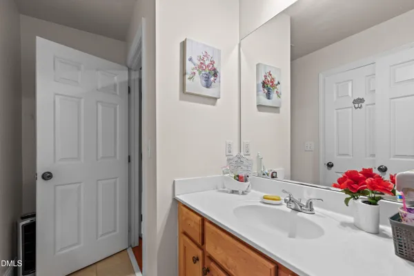 a bathroom with a sink vanity and a mirror