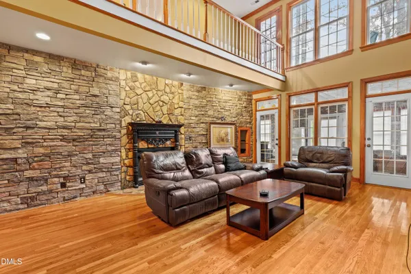 a living room with patio furniture and a fireplace