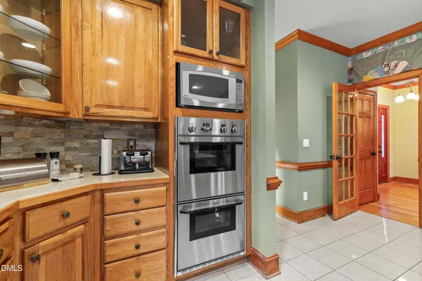 a kitchen with stainless steel appliances granite countertop a refrigerator and a stove