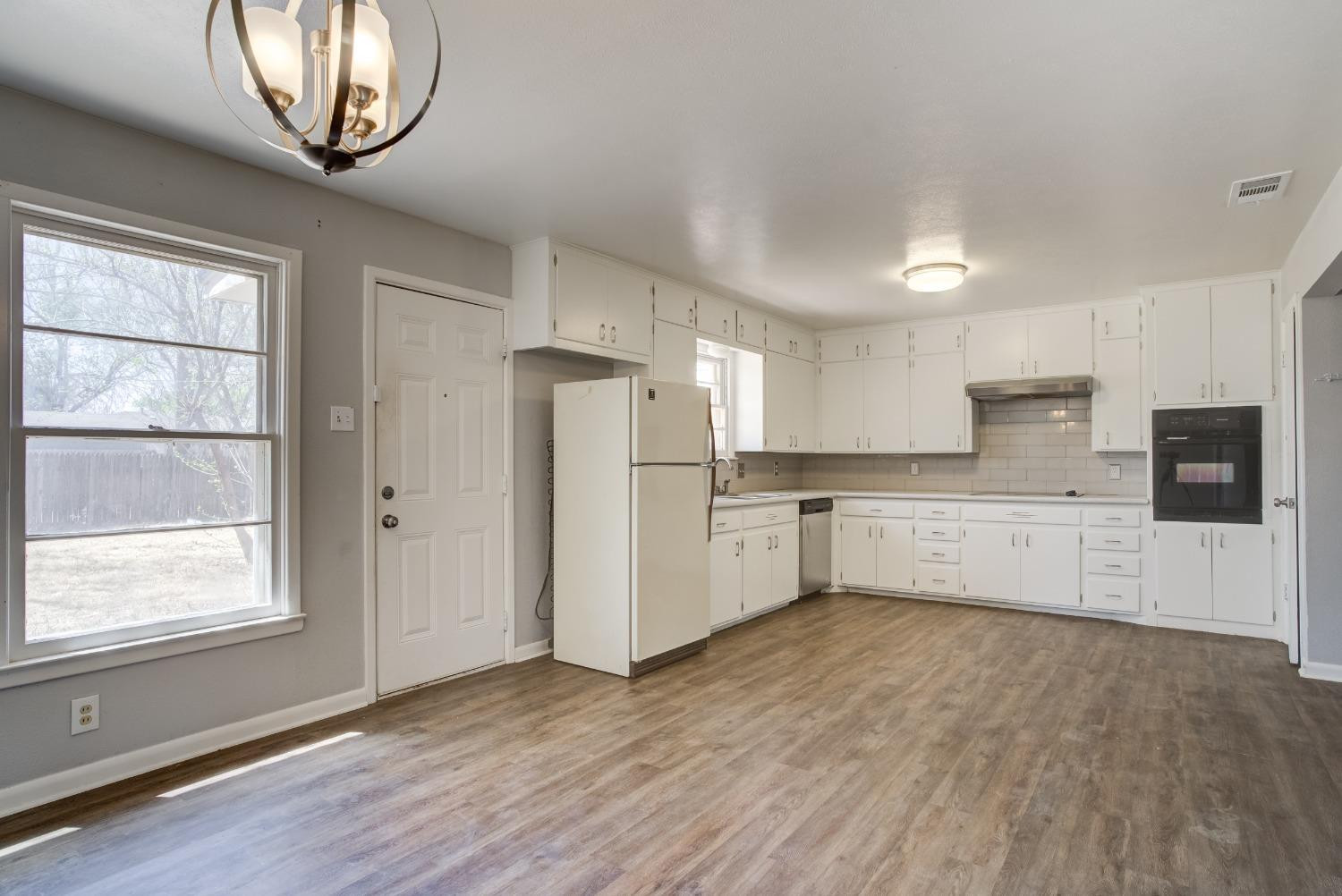 3011 44th Street Lubbock, TX 79413 - Photo 7 of 19 a kitchen with stainless steel appliances a refrigerator and a stove top oven