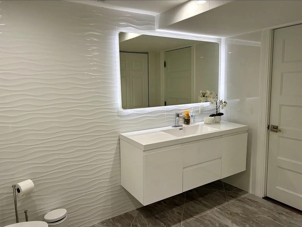 6 Temple Street Framingham, MA 01702 - Photo 13 of 34 a bathroom with a sink mirror and toilet