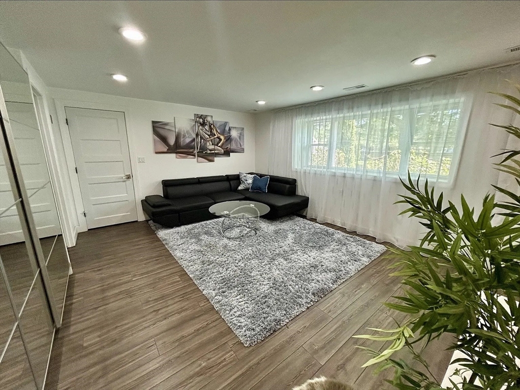 6 Temple Street Framingham, MA 01702 - Photo 22 of 34 a living room with a couch and a rug