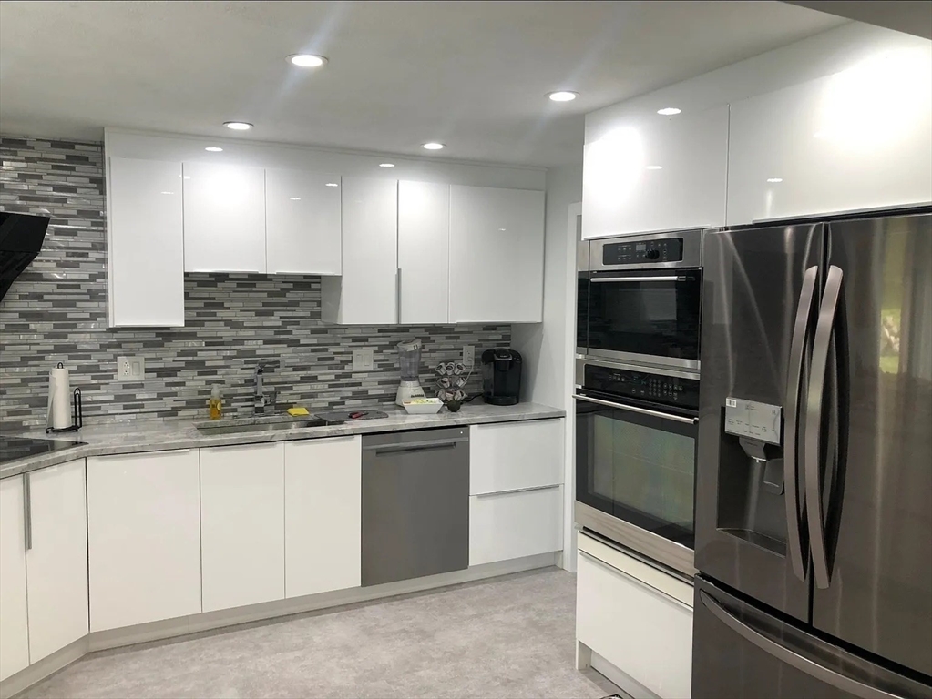 6 Temple Street Framingham, MA 01702 - Photo 28 of 34 a kitchen with stainless steel appliances granite countertop a refrigerator and a sink