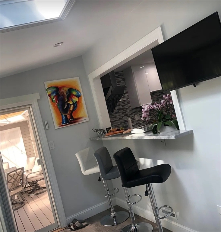 6 Temple Street Framingham, MA 01702 - Photo 31 of 34 a table chair sitting in a kitchen next to a window